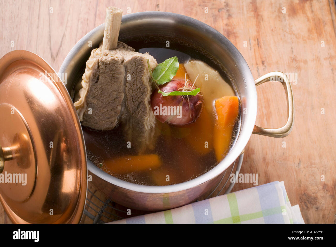 Broth with beef and soup vegetables in pot FoodCollection Stock Photo