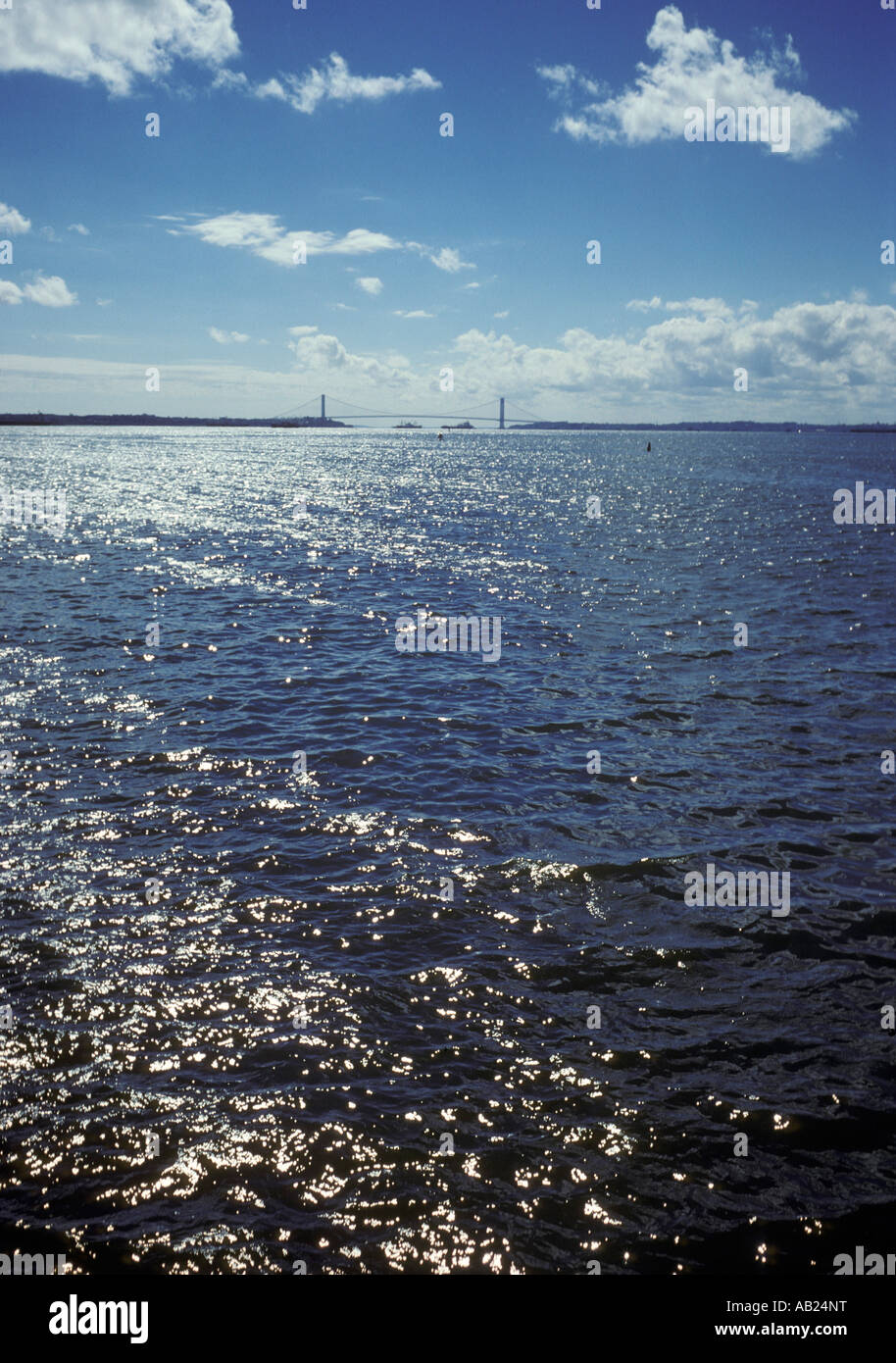 NYC Statue of Liberty New York Harbor New York city USA America Americana bright white fluffy clouds Stock Photo