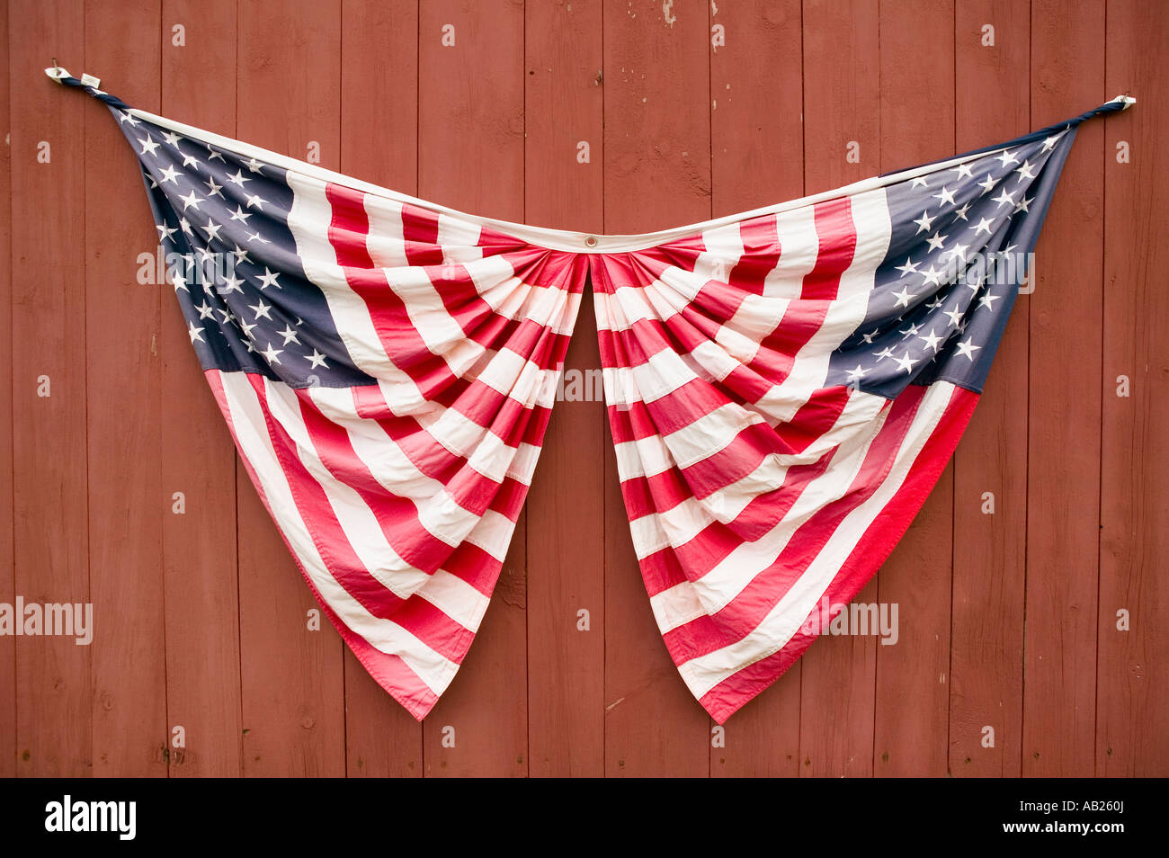 Two American flags displayed on side of red barn off of Manchester Road