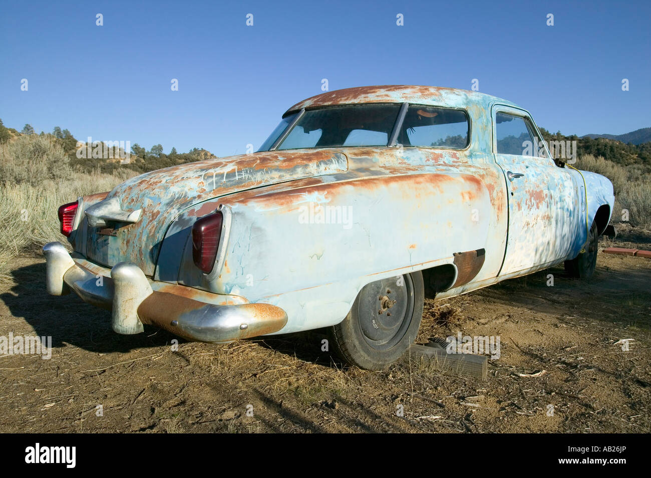 Junk early 50 s blue Studebaker deserted in field off highway 33 near Cuyama California Stock Photo