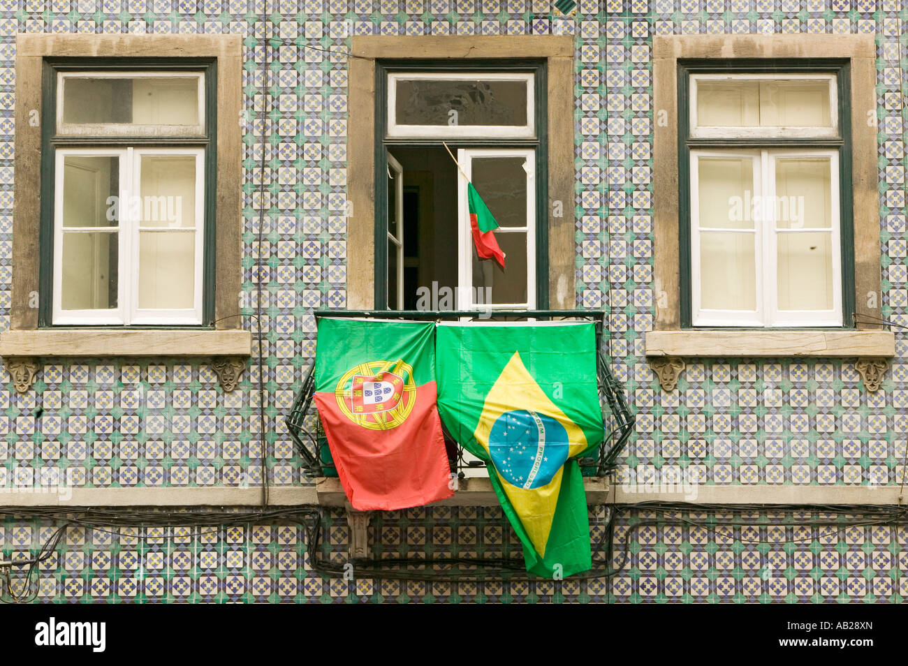 Portuguese and Brazilian flags are displayed from apartment balcony in Lisboa Lisbon Portugal in support of World Cup Soccer Stock Photo