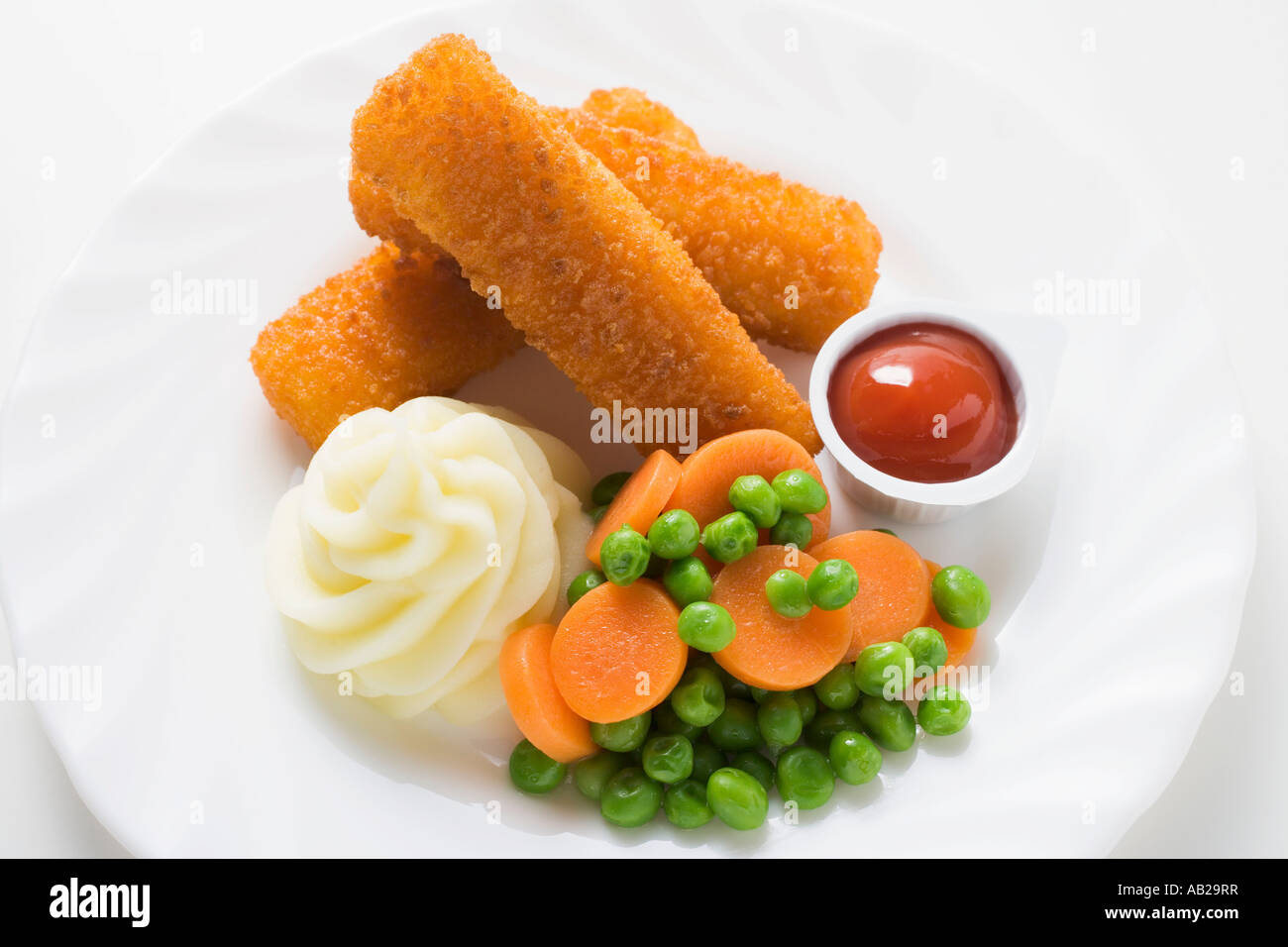 Fish fingers with mashed potato peas and carrots FoodCollection Stock Photo