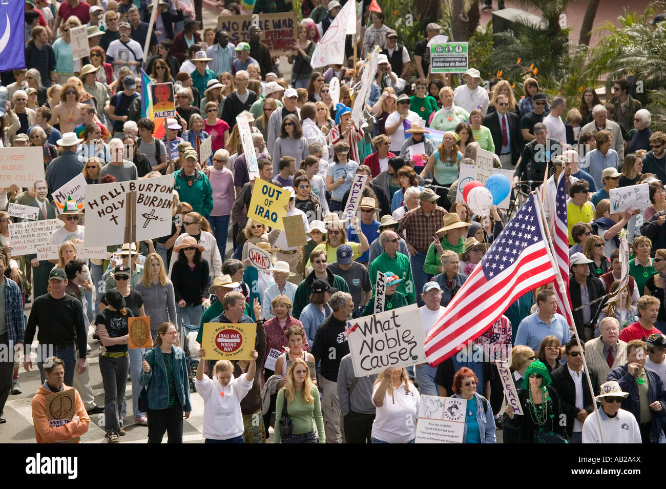 A large crowd of protesters march and chant down State Street carrying ...