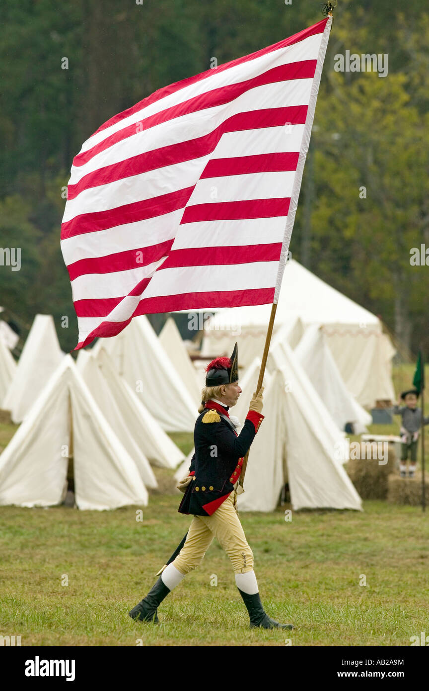 An early American flag is flown by solider on his way to Surrender Field at the 225th Anniversary of the Victory at Yorktown a Stock Photo