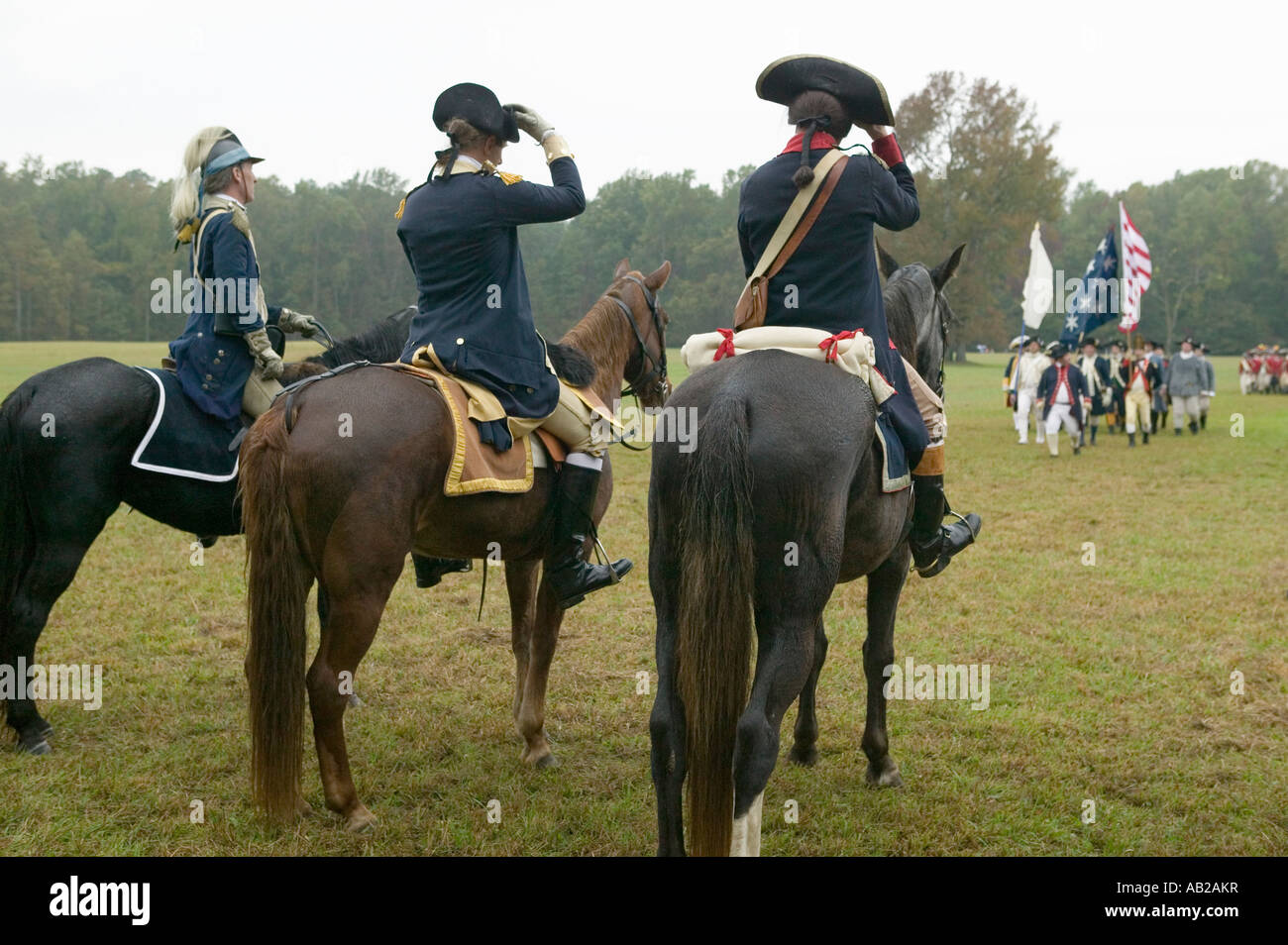 General George Washington and staff prepare to salute column of Continental Patriot troops at Surrender Field at the 225th Anniv Stock Photo