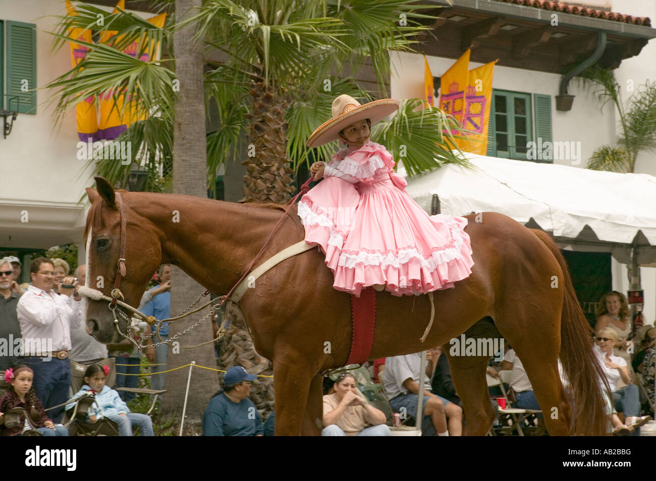 Young girl in pink dress rides horse in annual Old Spanish Days Fiesta