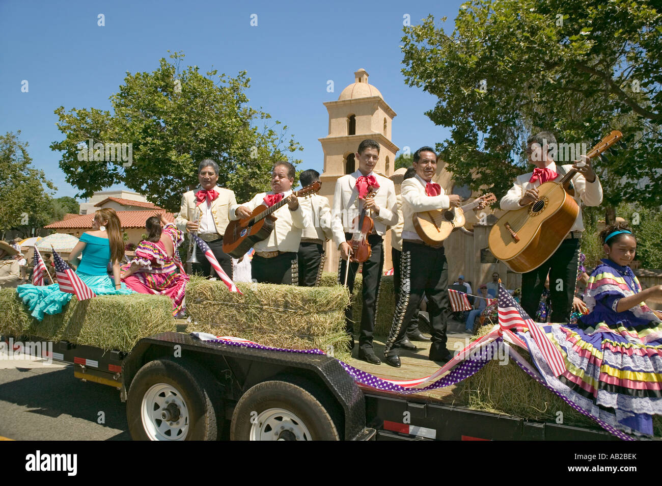 Festive float with singing Mariachis makes its way down main street during a Fourth of July parade in Ojai CA Stock Photo