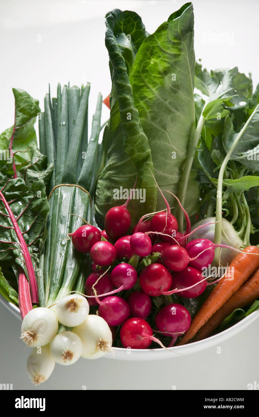 Spring onions radishes cabbage and carrots in bowl FoodCollection Stock Photo