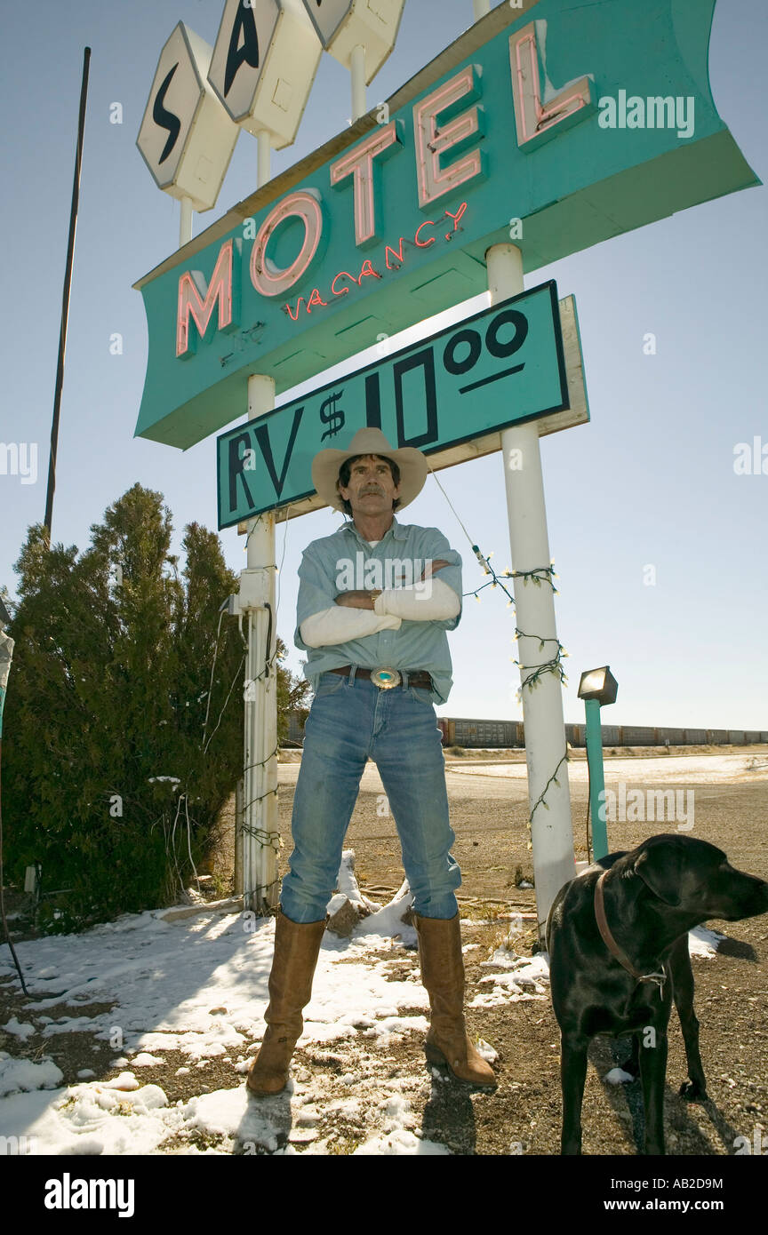 Cowboy with dog stand in front of Sands Motel sign with RV Parking for 10 located at the intersection of Route 54 380 in Car Stock Photo