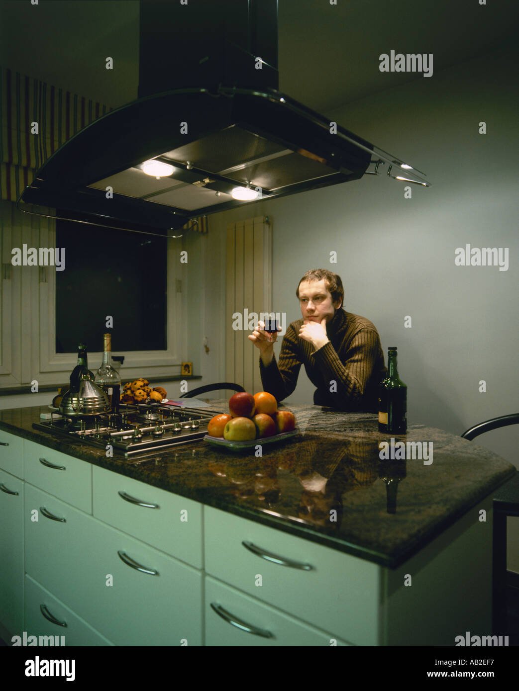 Man enjoying dinner in a kitchen Stock Photo