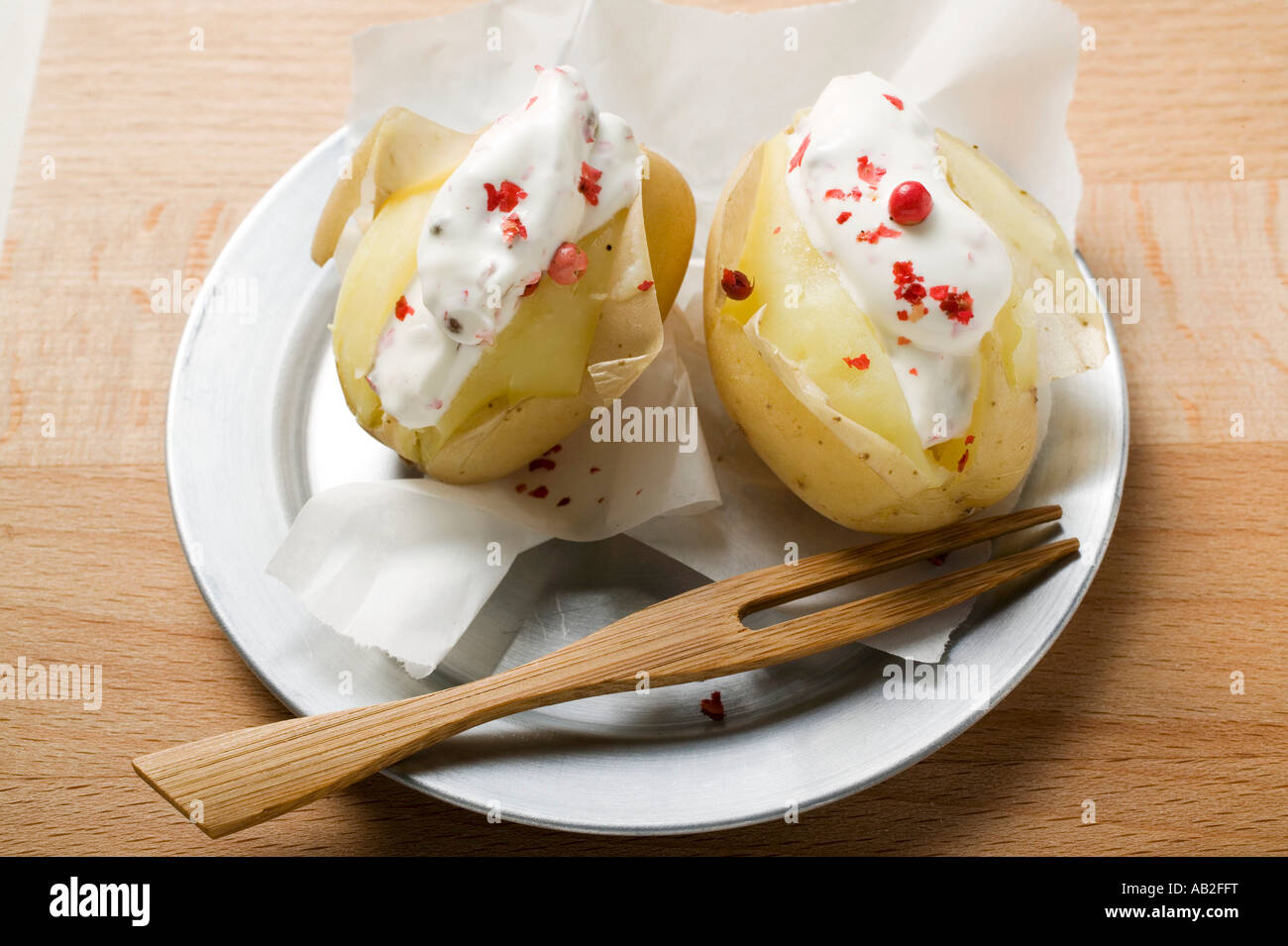 Potatoes cooked in their skins with sour cream red pepper FoodCollection Stock Photo