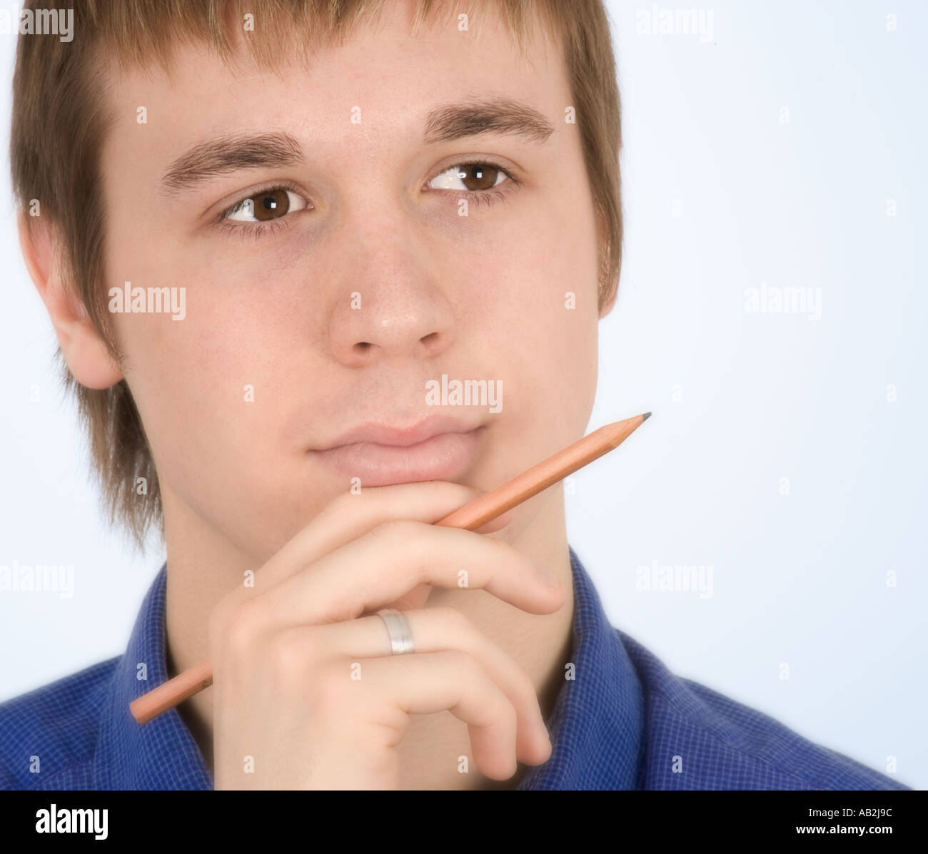 Thoughtful man with pencil Stock Photo