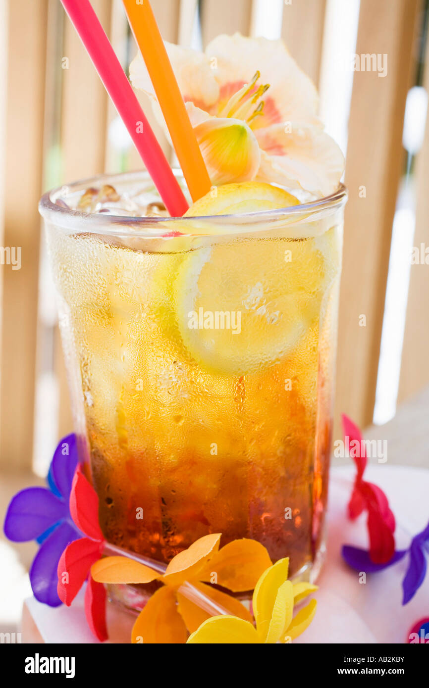 Cuba Libre with slice of lemon and amaryllis flower FoodCollection Stock Photo