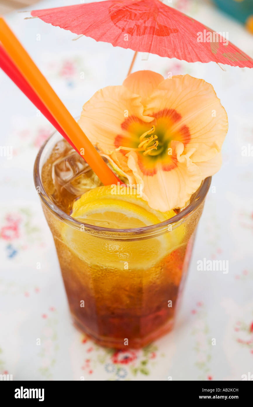 Cuba Libre with cocktail umbrella and amaryllis flower FoodCollection Stock Photo