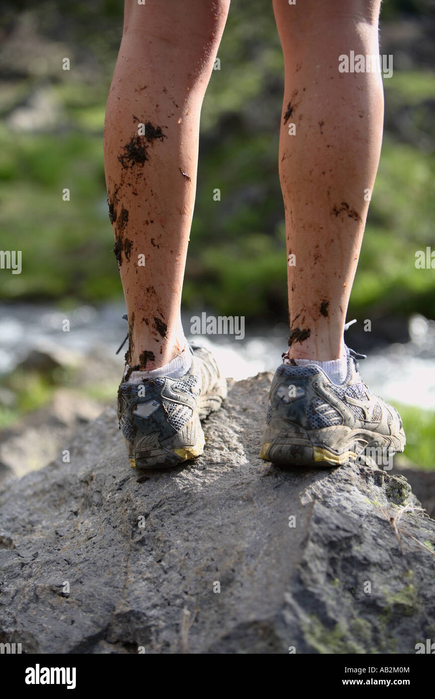 Hikers legs with mud splattering Stock Photo