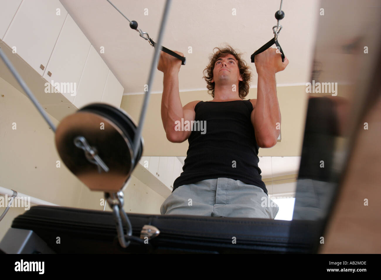 young man working out on exercise machine Stock Photo
