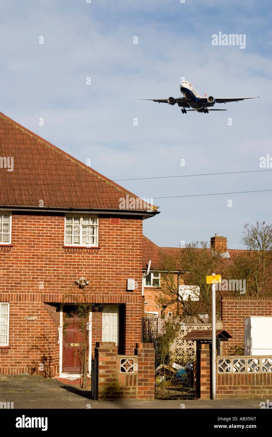 Low flying passenger airplane over houses on approach to London Stock