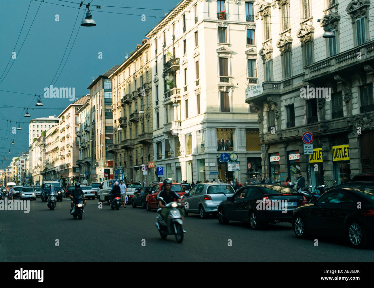 Scooters head one way and cars  clog up the other in rush hour on Corso Buenos Aires in Milan Stock Photo