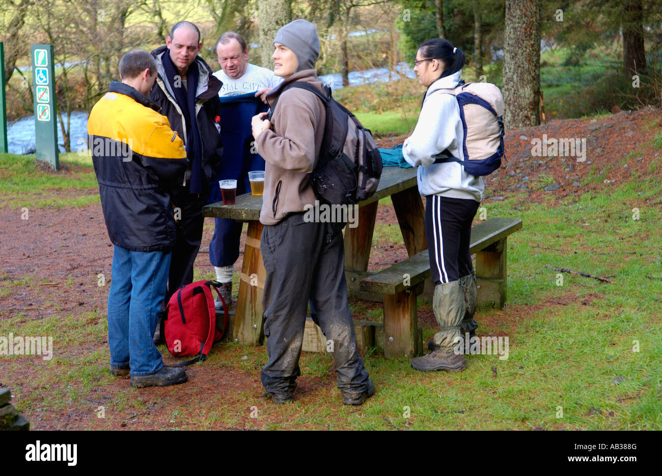 Walkers taking part in the Real Ale Ramble Walking Festival stop for a ...