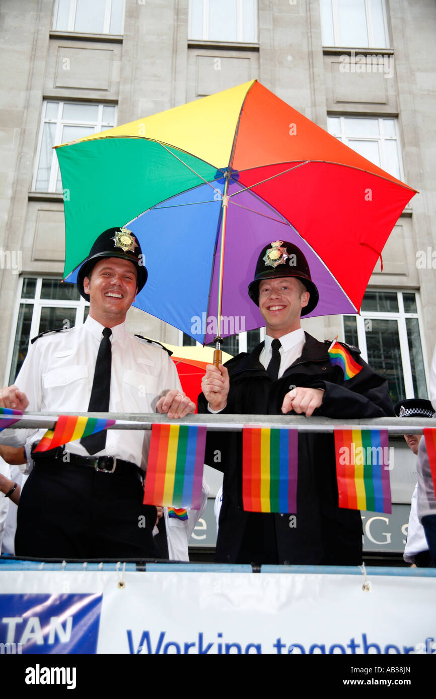 Policemen from the Gay Police Associatian under a rainbow umbrella at the 2007 London Gay Pride March Stock Photo