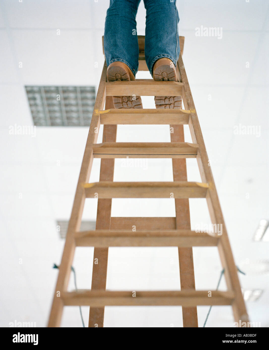 feet at the top of ladders Stock Photo