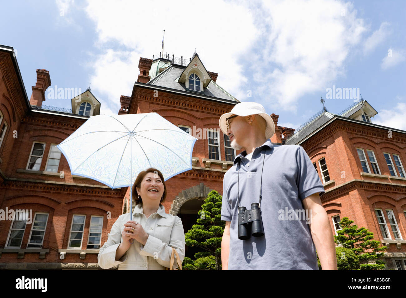 Senior couple standing in front of building Stock Photo - Alamy