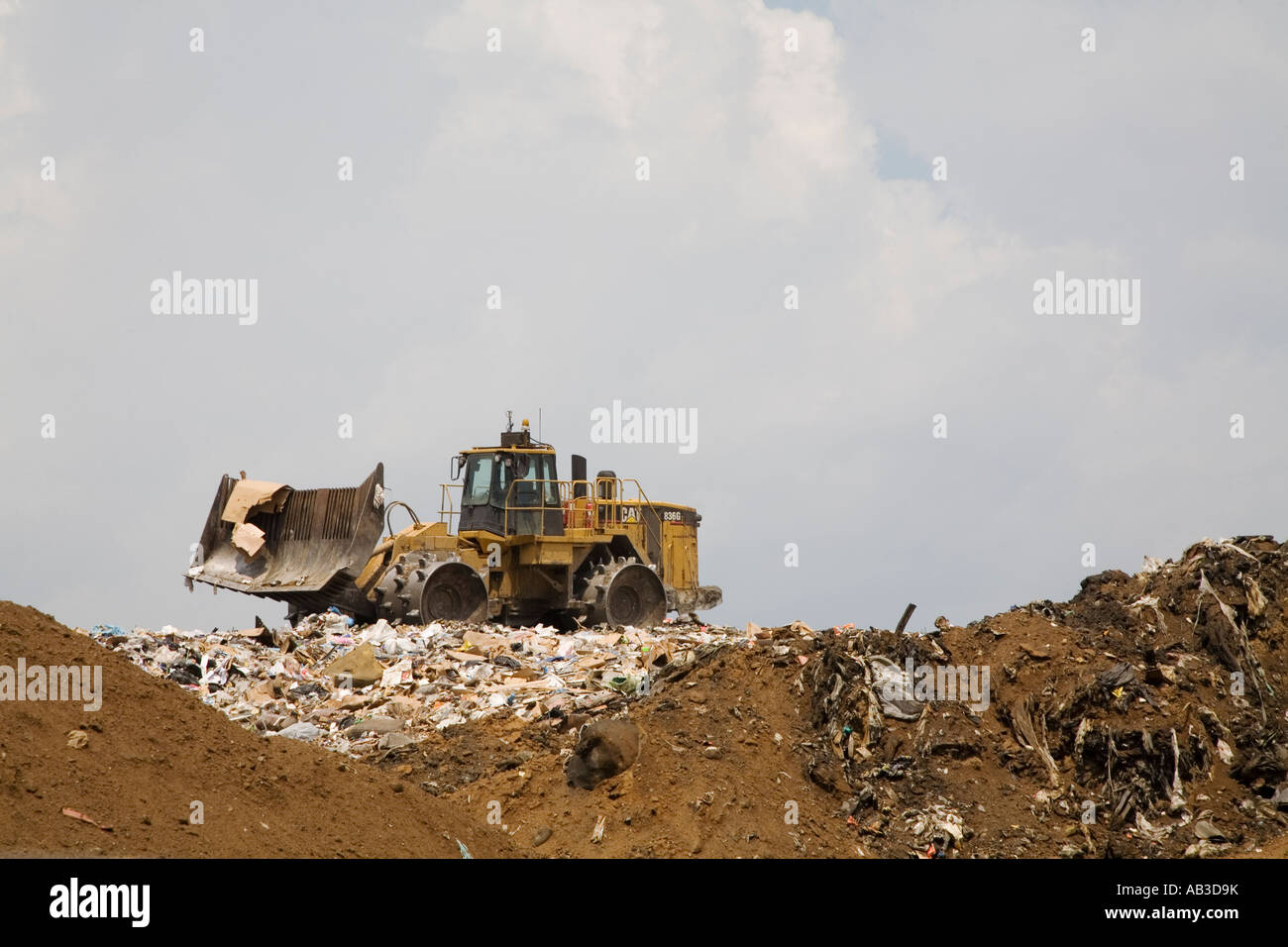Marshall Michigan A bulldozer levels newly arrived garbage at the C C Landfill Stock Photo