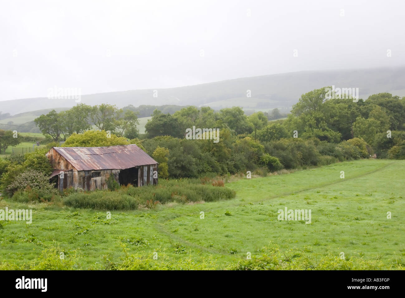 Derelict empty old barn building in wet weather, Swanage, UK Stock ...