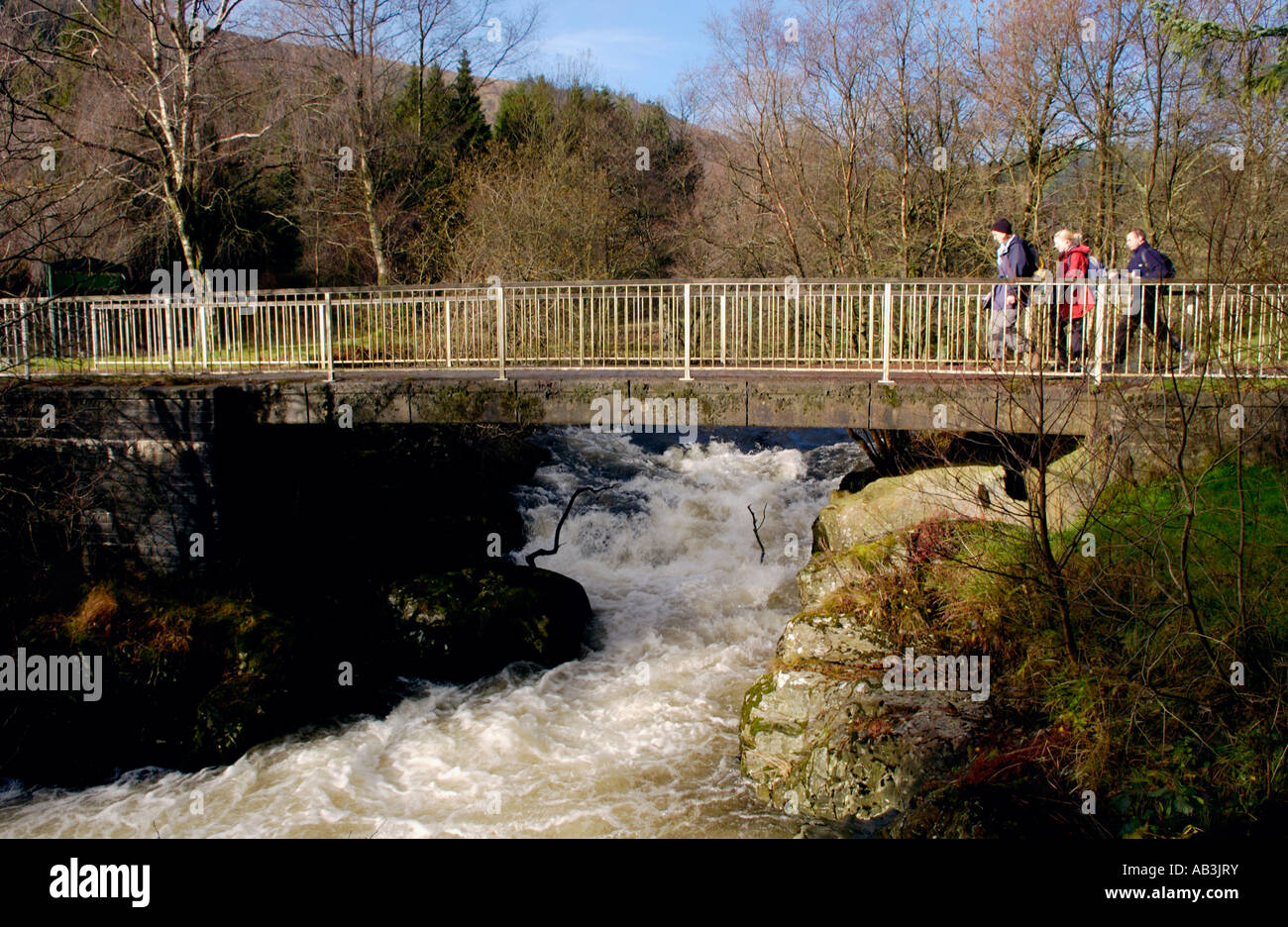 Walkers taking part in Real Ale Ramble walking festival cross the fast ...