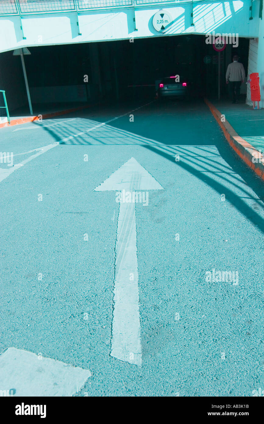 Arrow signalling direction into underground parking garage Stock Photo