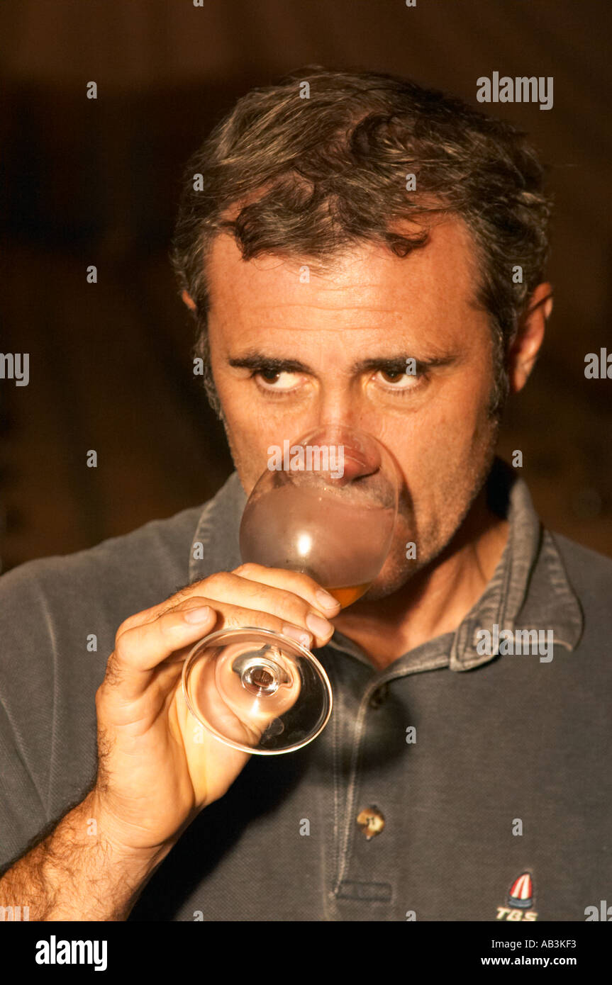 Herve Lamothe, owner and wine maker, tasting his wine in the cellar