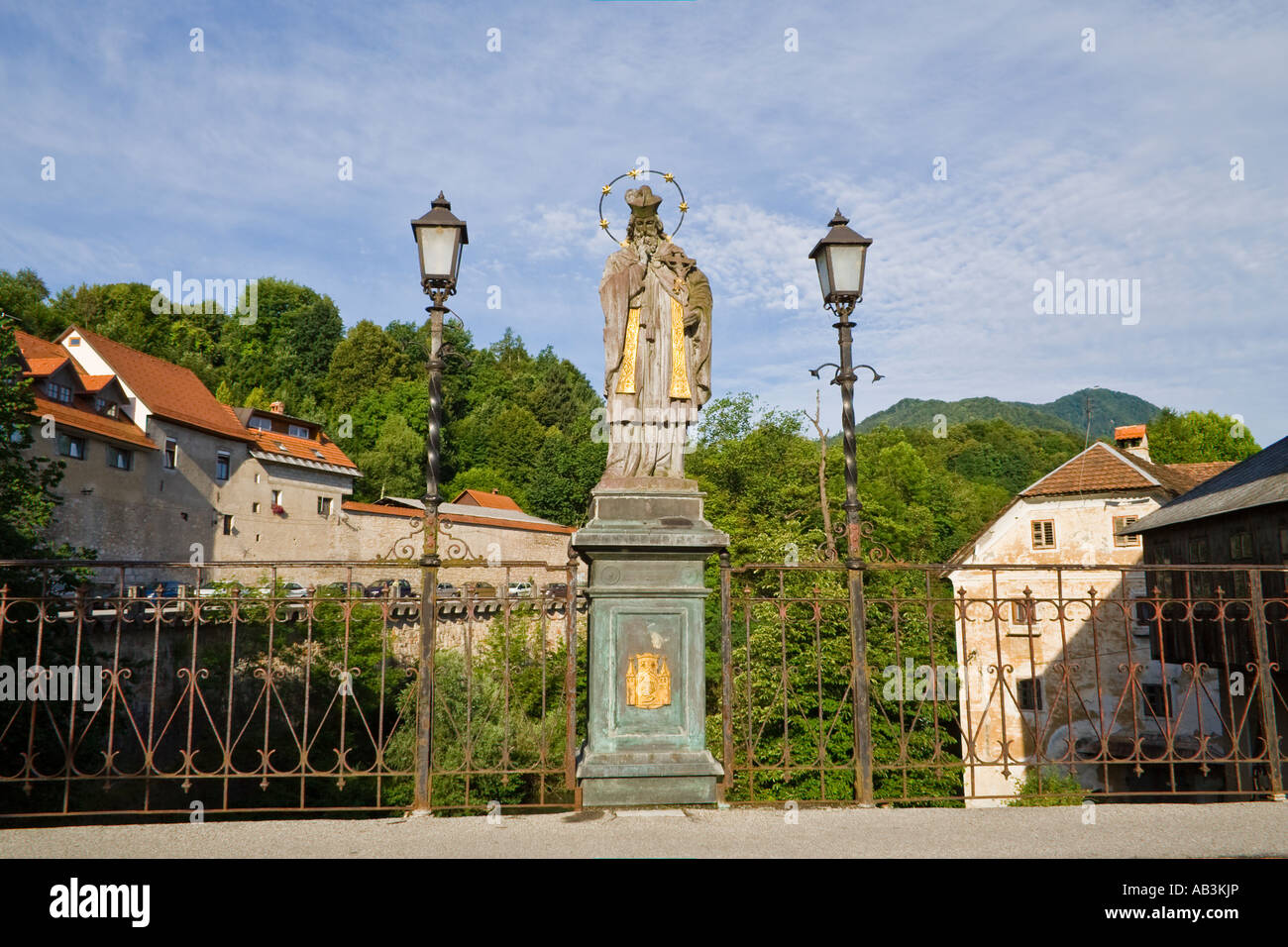 A statue of St. Janez Nepomuk on the Cappuchin Bridge from14th century is the oldest preserved bridge in Slovenia. Stock Photo