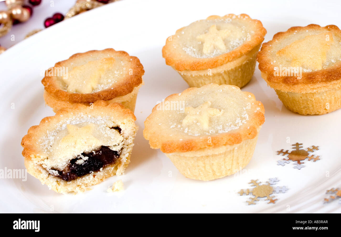mince pies on a white plate with confetti stars Stock Photo - Alamy