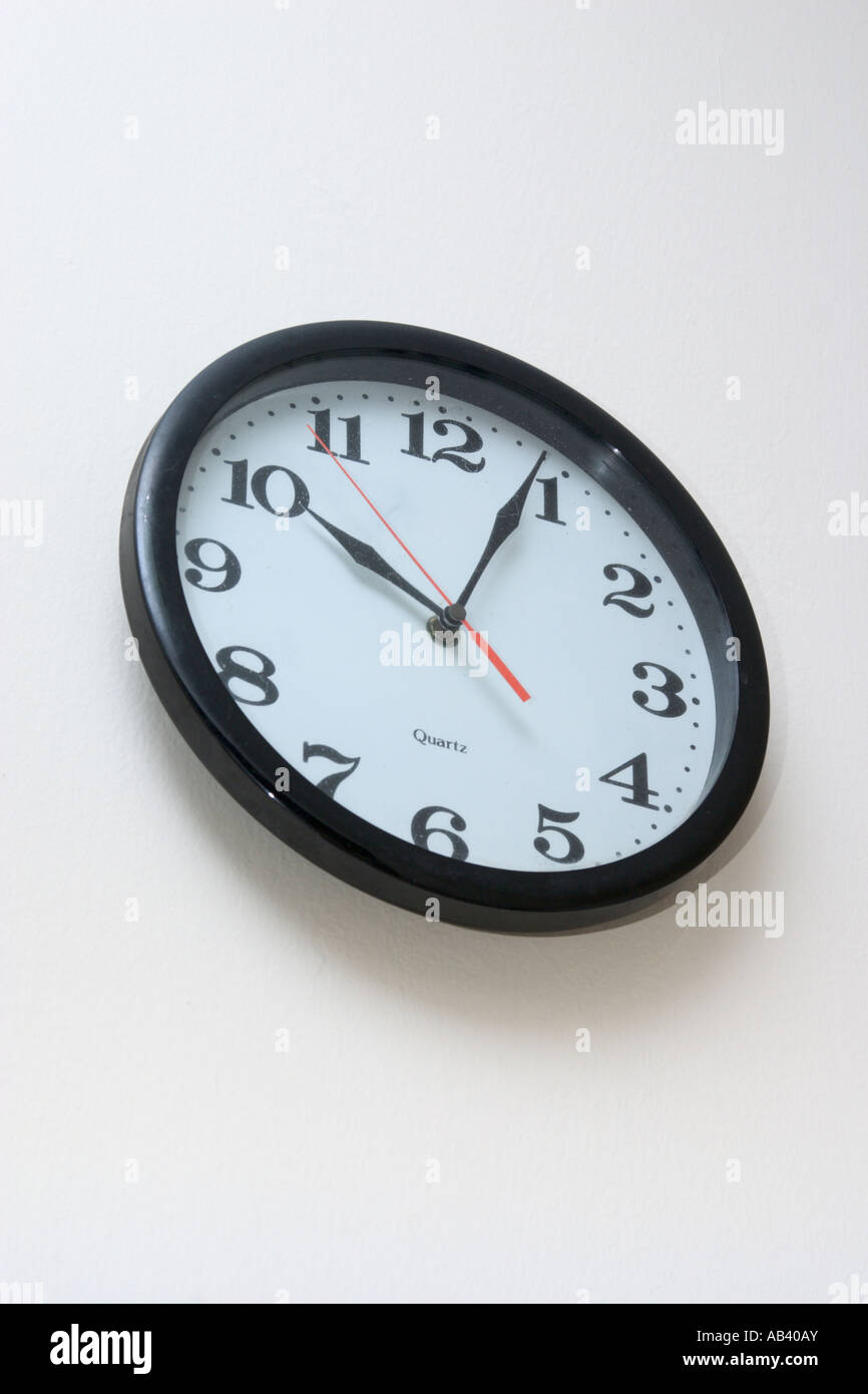 clock hung on wall with hands showing v shape Stock Photo Alamy