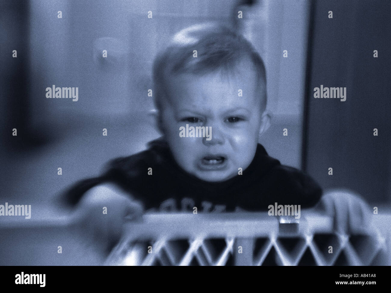 Baby crying in playpen Stock Photo