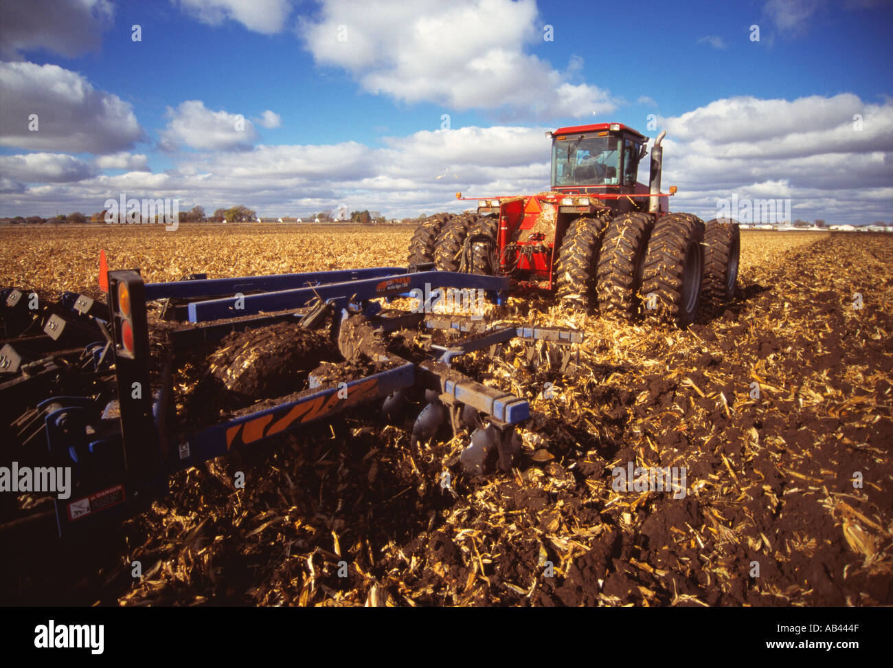 Agriculture 4WD tractor chisel plowing a field of corn stubble in Autumn in preparation for