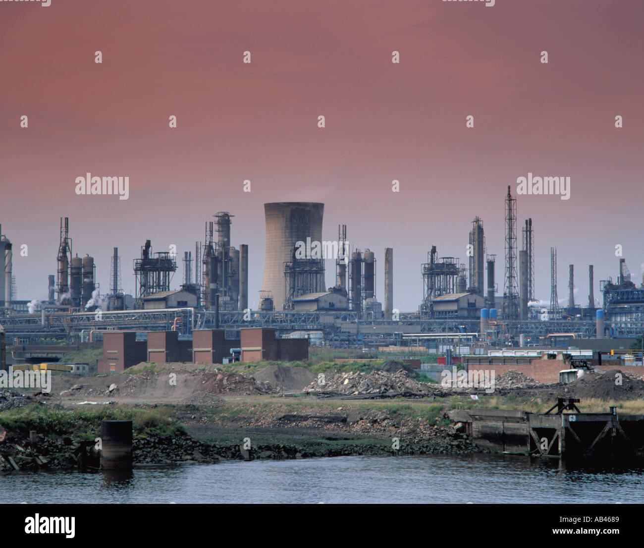 Chemical complex and cooling tower seen over River Tees and derelict land, Billingham, Teesside, Cleveland, England, UK. in the 1980s Stock Photo