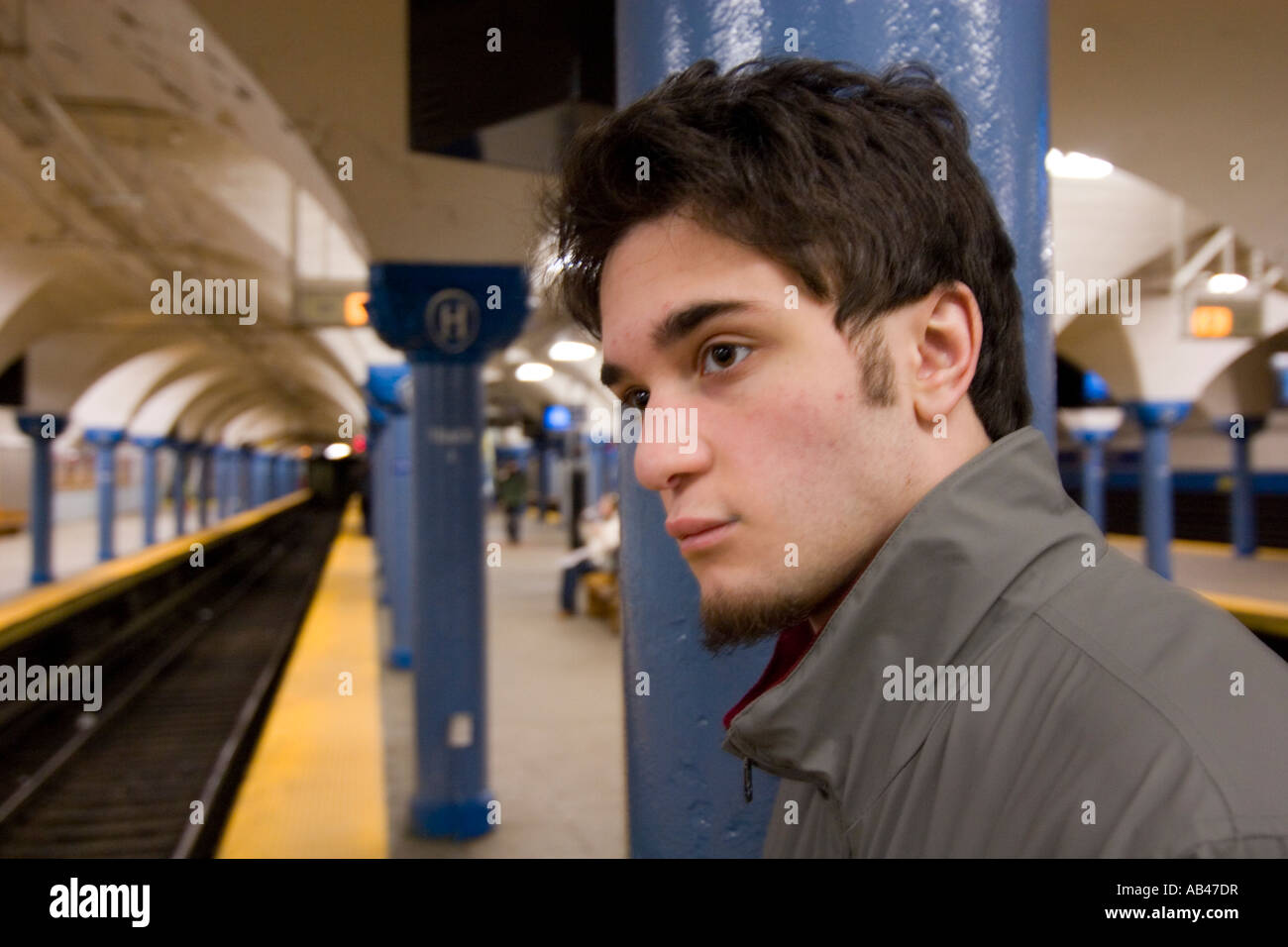 A young man waiting for a subway in a subway station Stock Photo