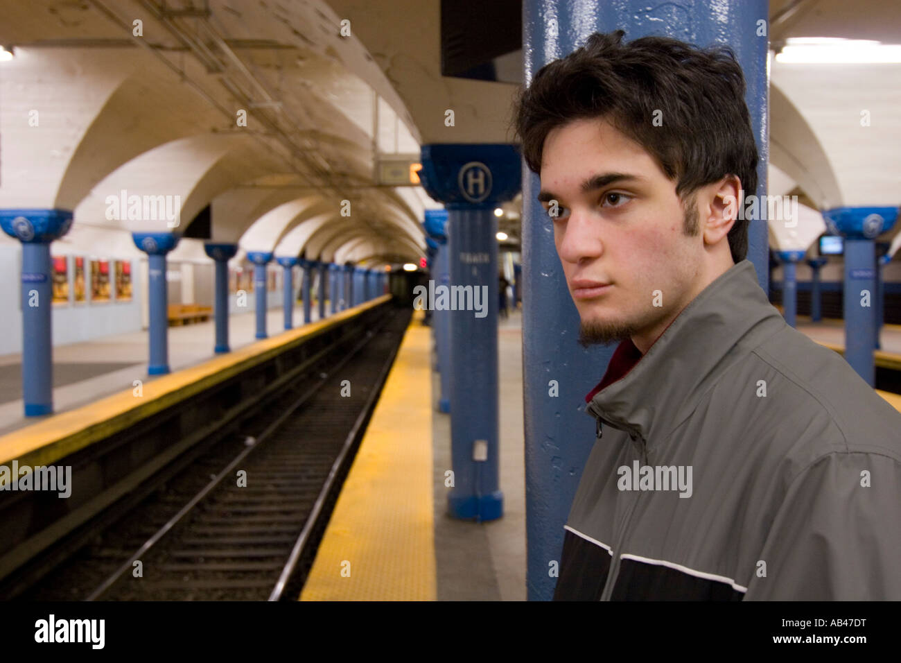 A young man waiting for a subway in a subway station. Stock Photo