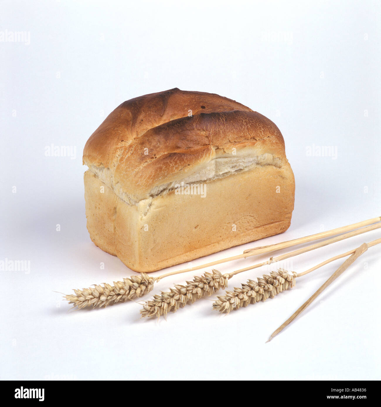 A loaf of white bread with ears of wheat Stock Photo - Alamy