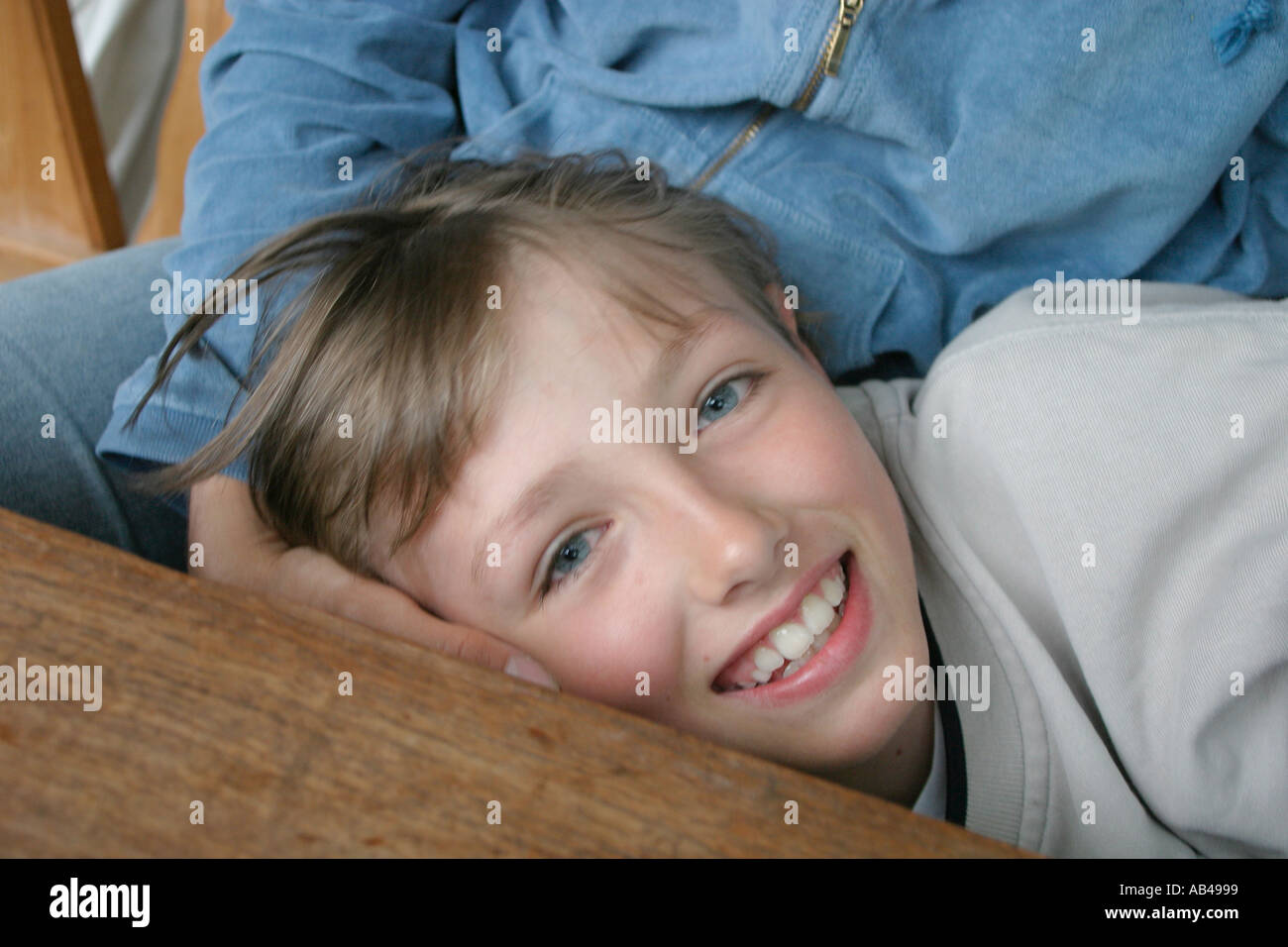 Happy boy on the lap of his mother Stock Photo