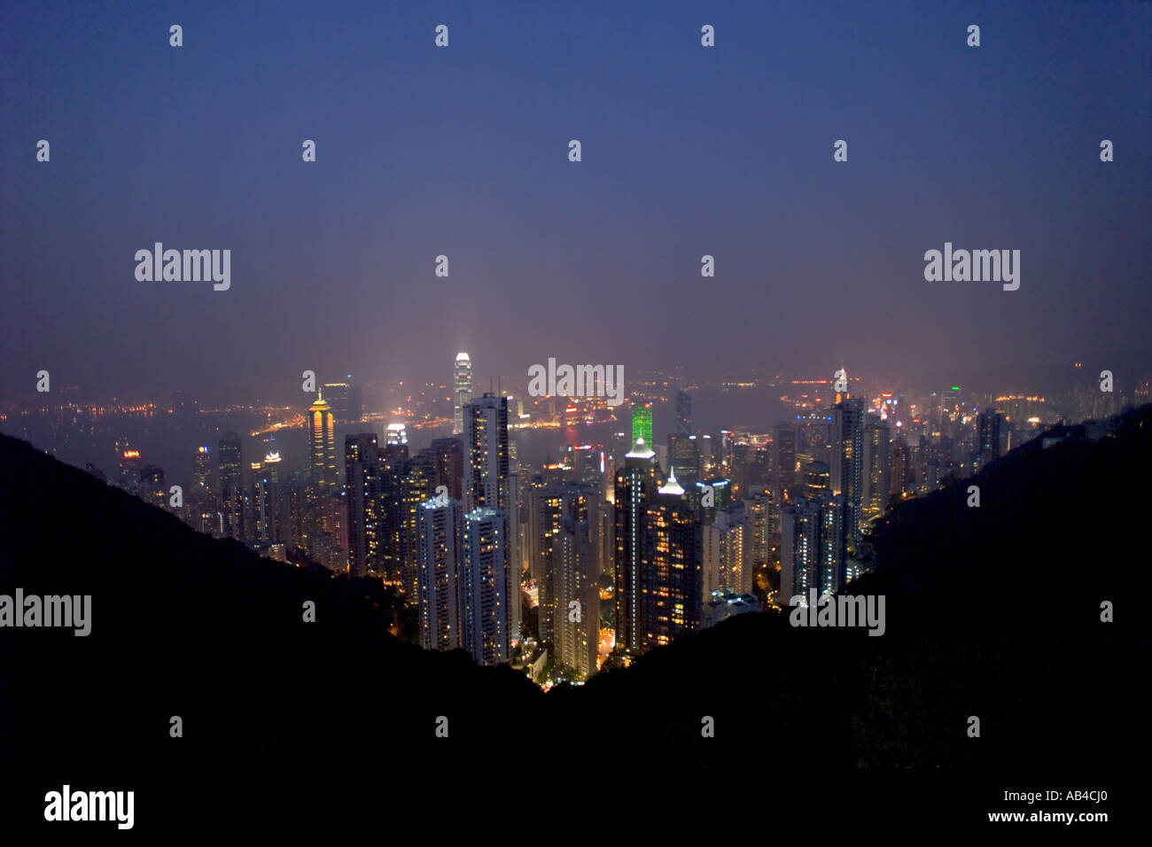 An aerial view over Hong Kong and Victoria Harbour at night/sunset/dusk taken from the Peak. Stock Photo