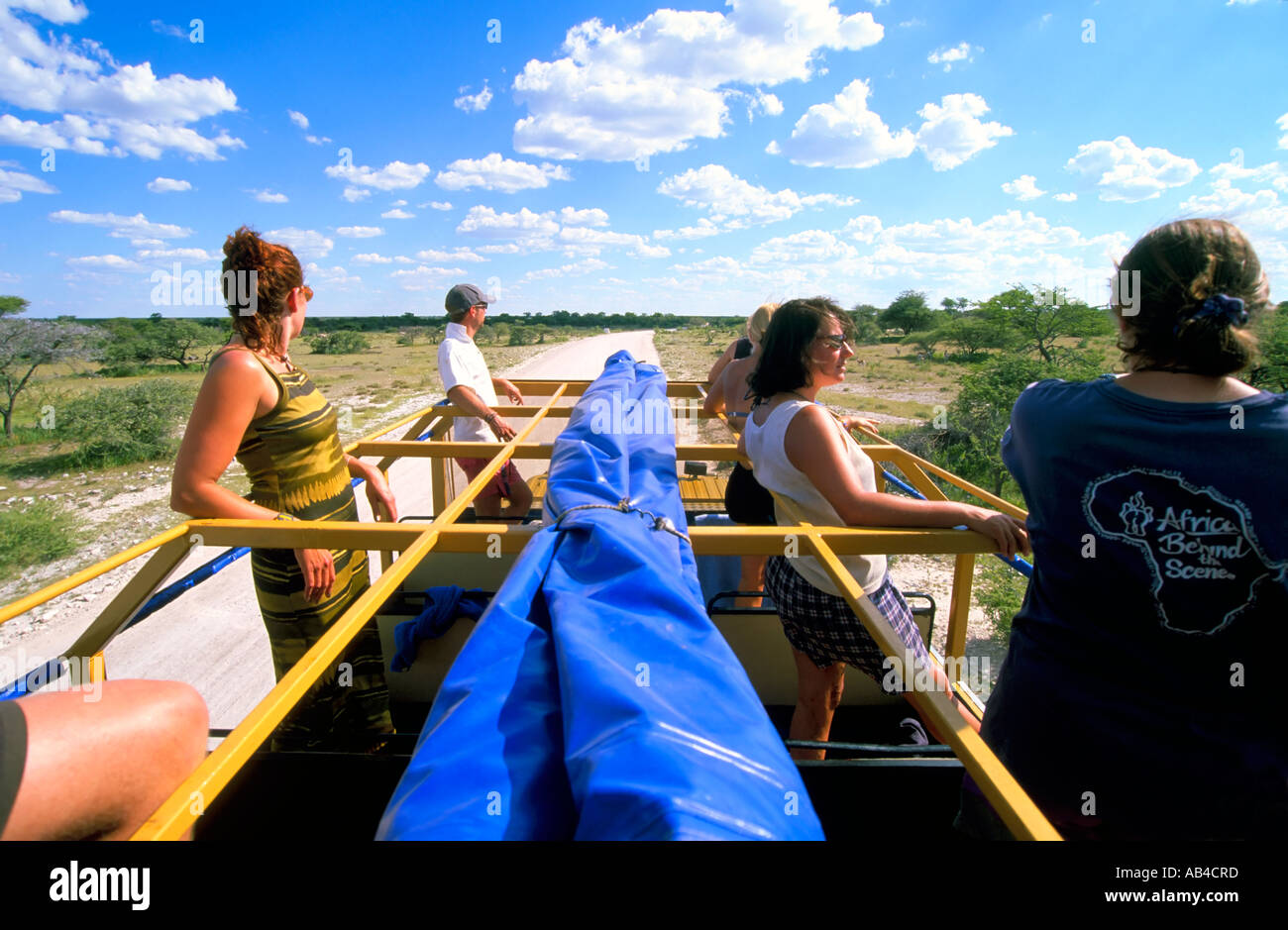 Tourists game viewing from the roof of an overland 4wd truck vehicle in Etosha National Park. Stock Photo