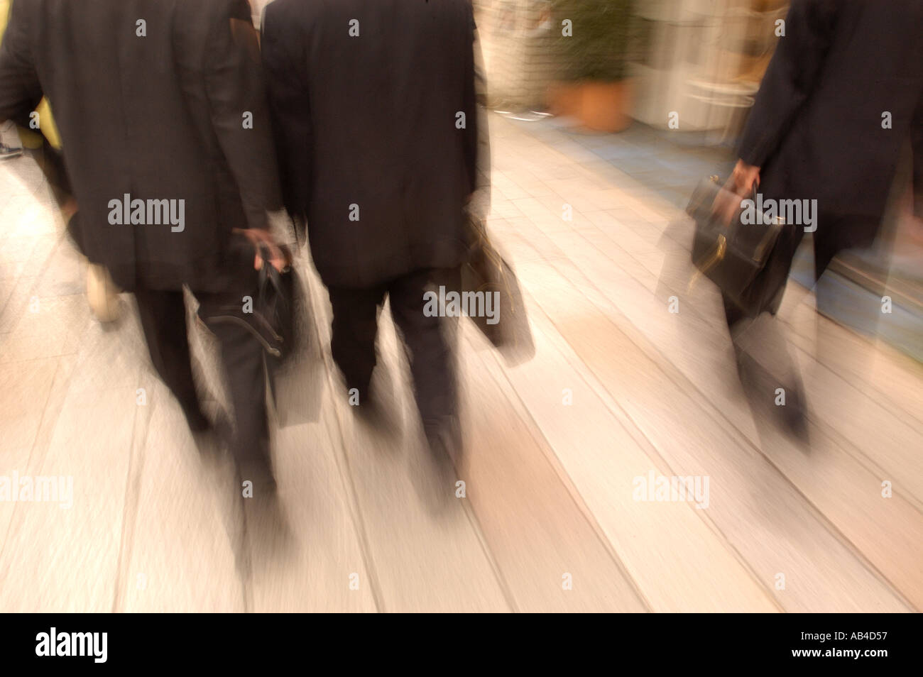 Businessmen walking on the street in Tokyo- slow shutter speed blurred image Stock Photo