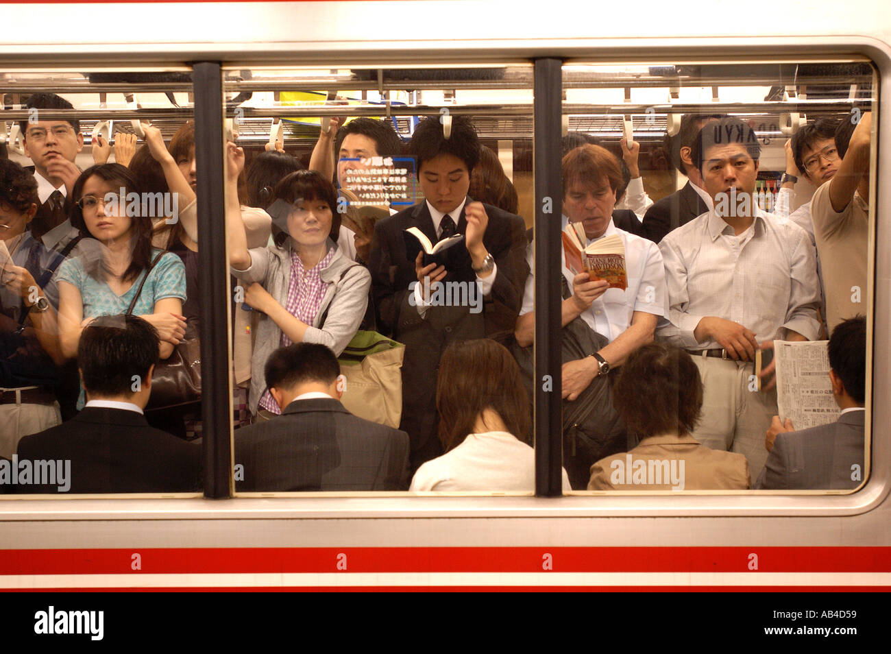 Overcrowded subway carriage at rush hour at Shinjuku Station Tokyo Japan Stock Photo