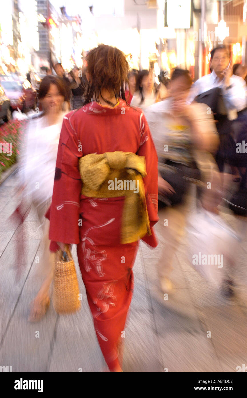 A woman in kimono shopping at night in Ginza Tokyo Japan Stock Photo