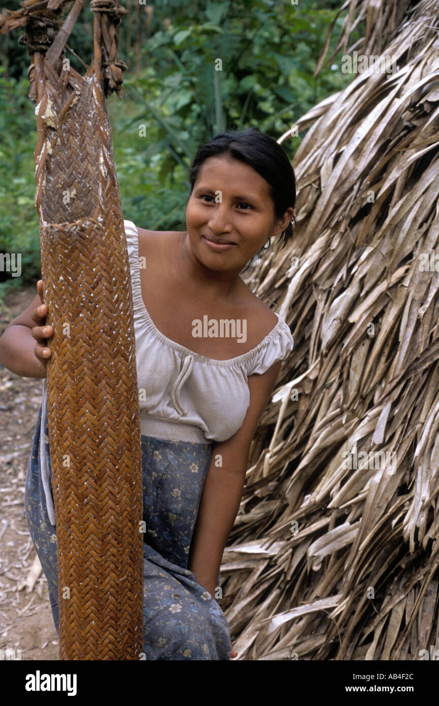 A Piaroa Indian woman stands beside a woven filter used to extract toxins from ground yucca root near Puerto Ayacucho Venezuela  Stock Photo