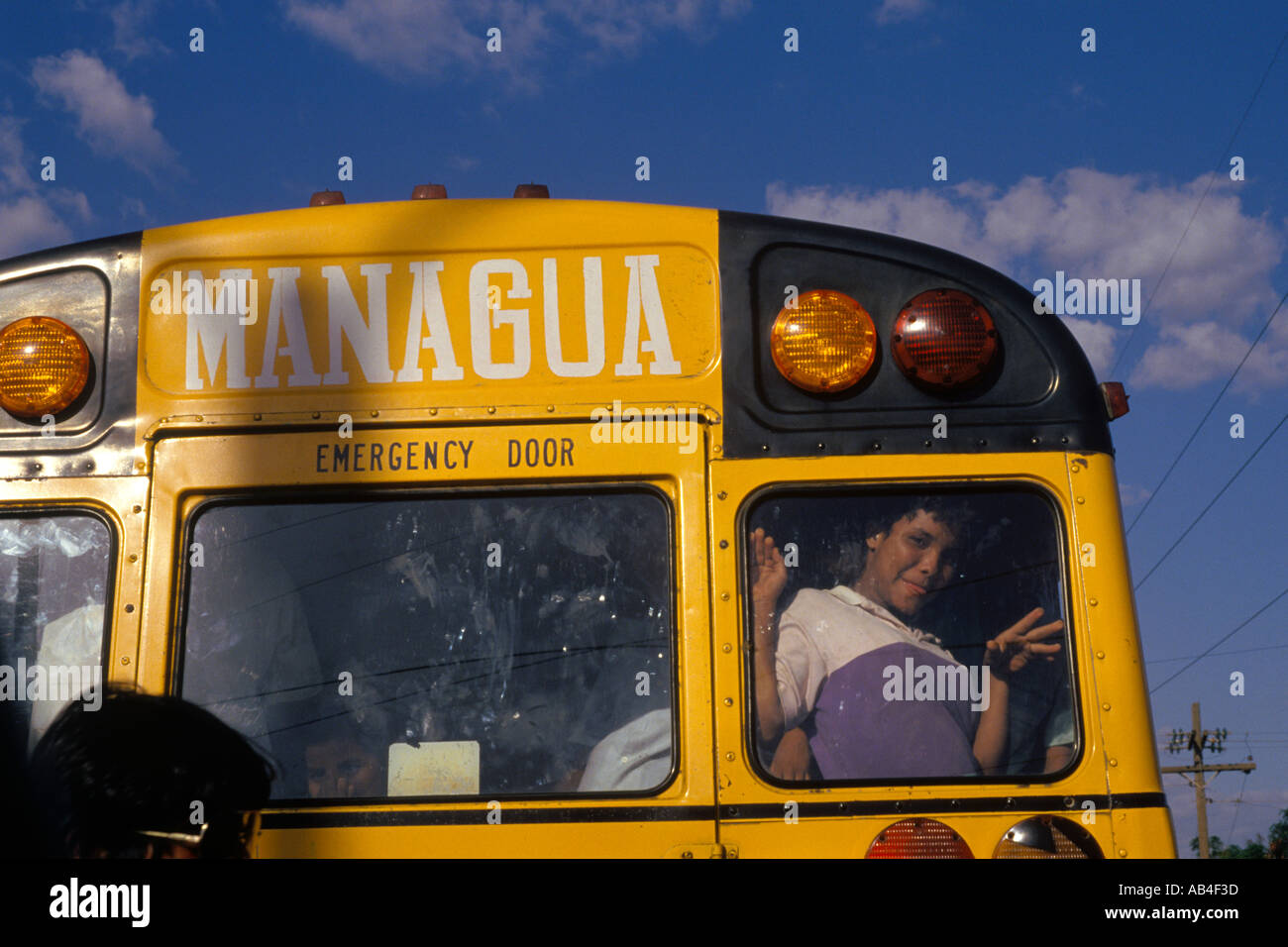 A teenage boy looks out the back of a converted US school bus now used