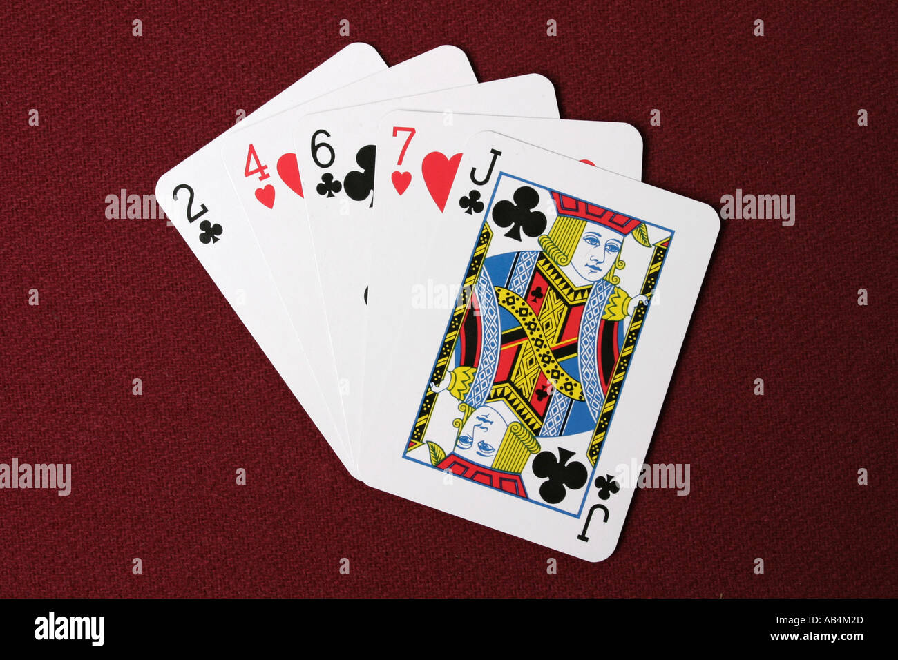 A high card poker hand cards fanned out on a red dealers table Stock Photo  - Alamy