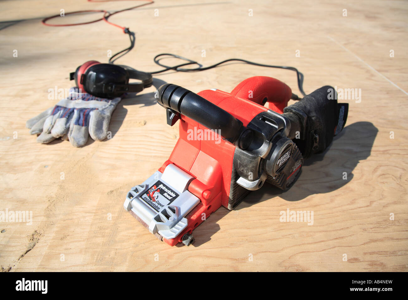 Home renovation concept belt sander with work gloves Stock Photo Alamy